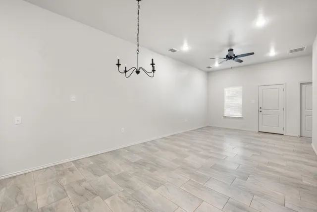 a view of an empty room with a ceiling fan