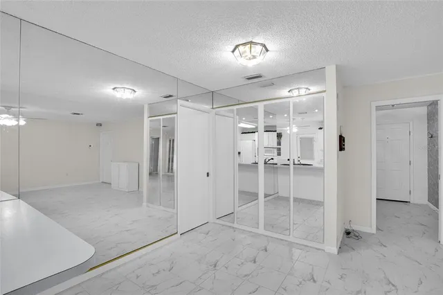 a view of a hallway with wooden shelves