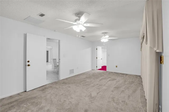 a view of empty room with fan