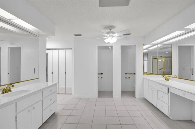 a spacious bathroom with a double vanity sink mirror and
