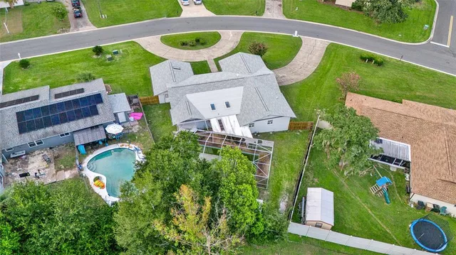 an aerial view of a house with a swimming pool