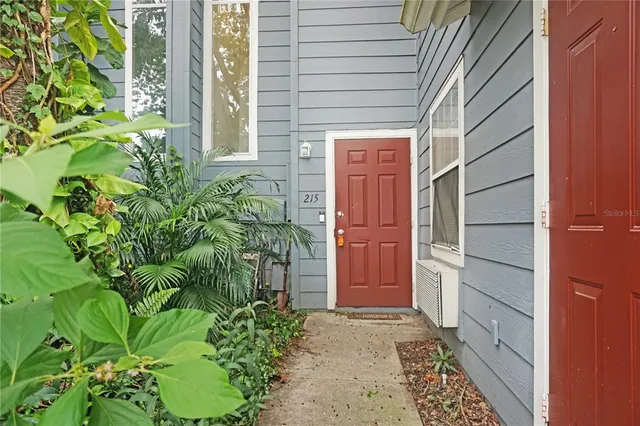 a backyard of a house with potted plants