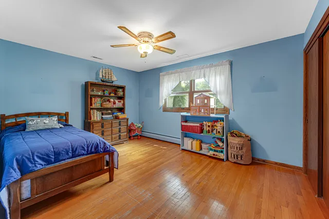 a bedroom with furniture and a wooden floor