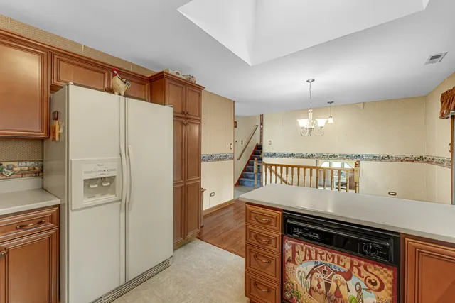 a kitchen with stainless steel appliances granite countertop a refrigerator and a stove