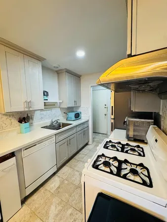 a kitchen with a stove a sink and a refrigerator