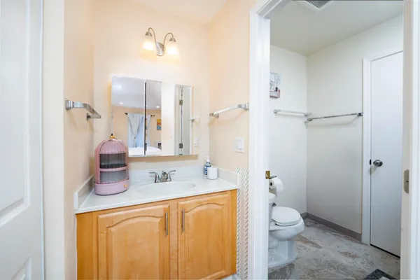 a bathroom with a granite countertop sink toilet and shower