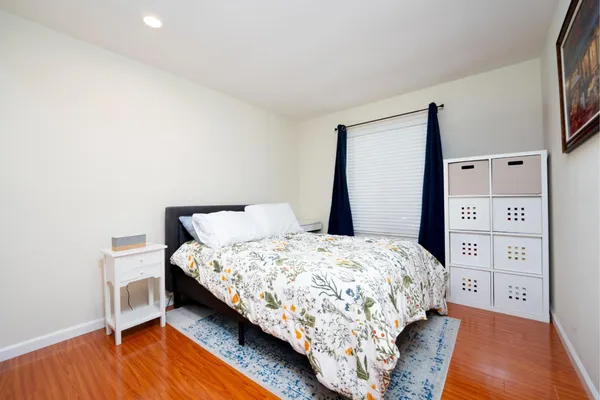 a bedroom with a bed and a night stand