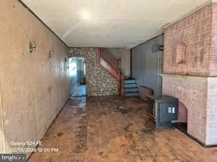 a view of empty room with fireplace