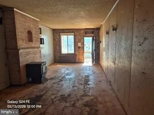 a view of livingroom with fireplace and window