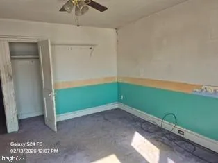 an empty room with windows and closet