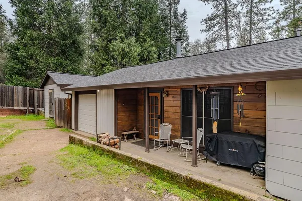 a view of a house with backyard and sitting area