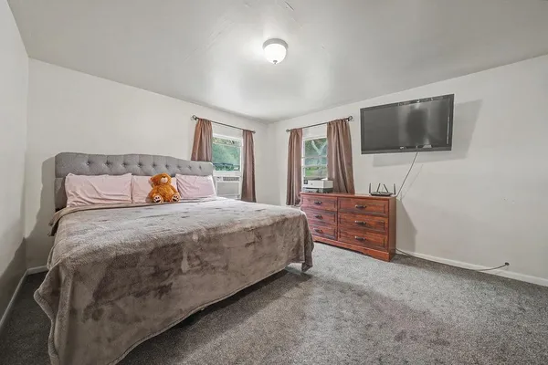 a bedroom with a bed and a book shelf