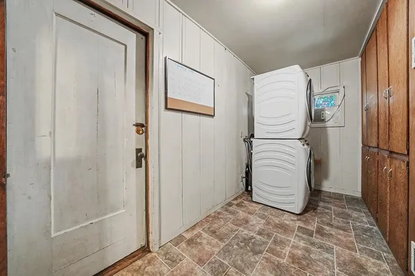 a spacious bedroom with a bed and wooden floor