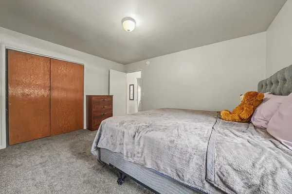a bedroom with furniture and a window