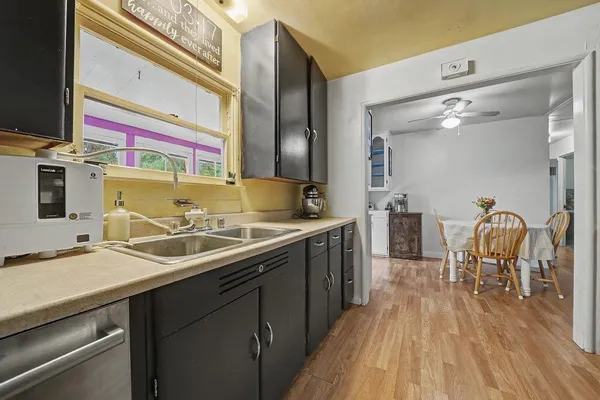 a kitchen with a sink and a stove top oven