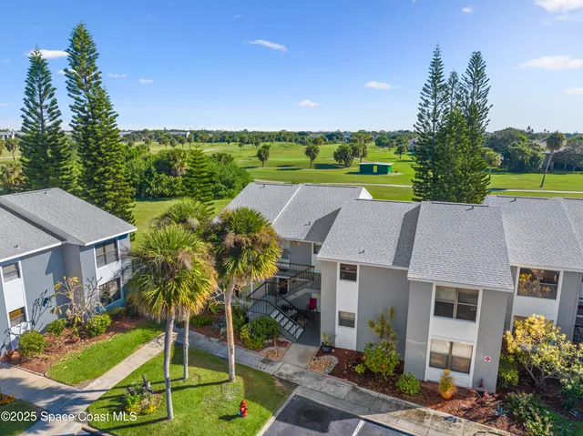 an aerial view of a house with garden space and street view