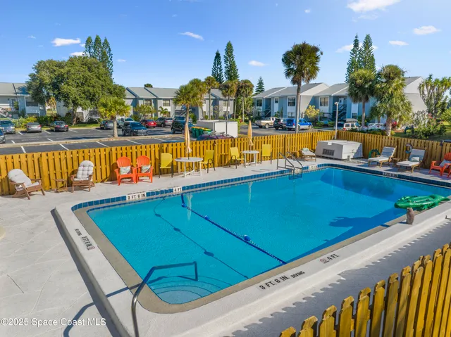 a view of a swimming pool with outdoor seating