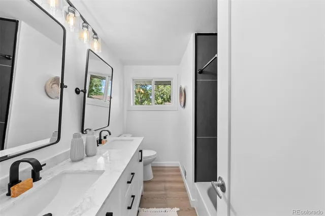 a bathroom with a double vanity sink and a mirror
