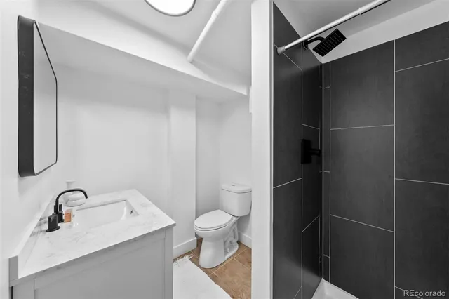 a bathroom with a sink toilet and a shower