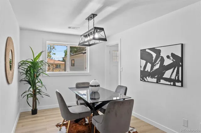 a view of a dining room with furniture wooden floor and chandelier