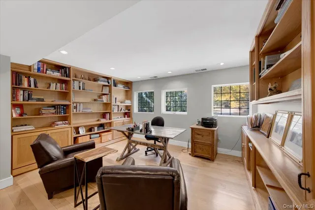 a view of a livingroom with workspace and a window