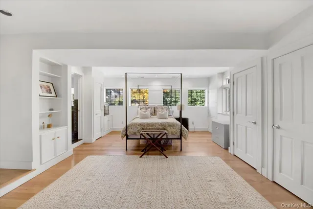 a bedroom with furniture and a window