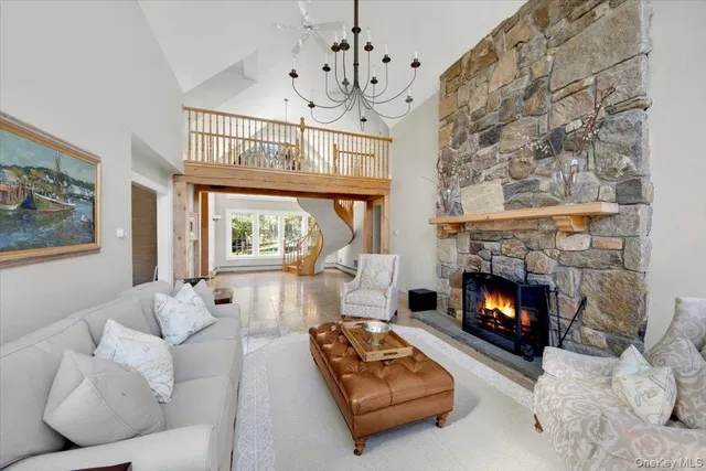 a living room with furniture a fireplace and a large window