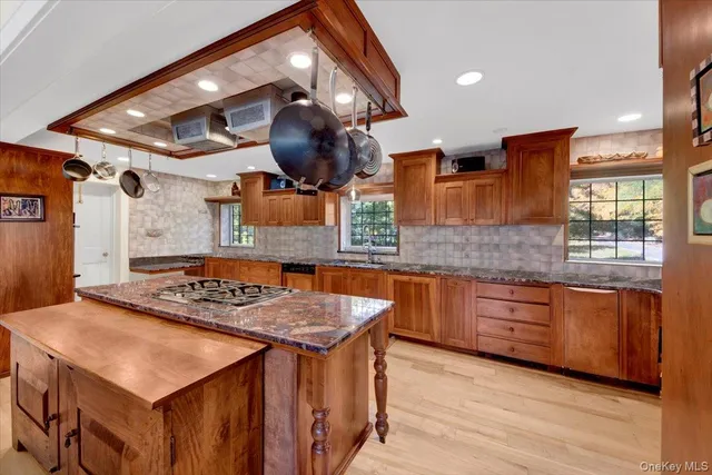 a kitchen with a stove a sink and a wooden cabinets