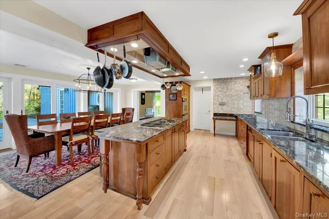 a kitchen with stainless steel appliances granite countertop a stove and a wooden floors