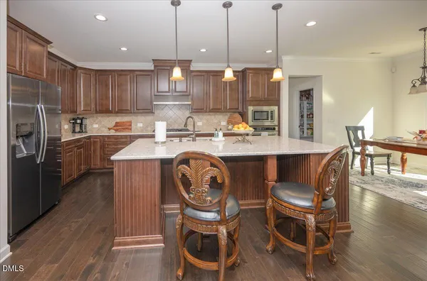 a large white kitchen with a large window