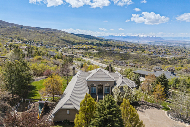 1714 Ridge Point Drive Bountiful, UT 84010 - Photo 7 of 132 Expansive property featuring a tiled roof, multiple chimneys, and a paved driveway