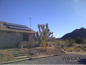 16550 Alamo Road Yucca, AZ 86438 - Photo 3 of 23 a view of a house with a yard