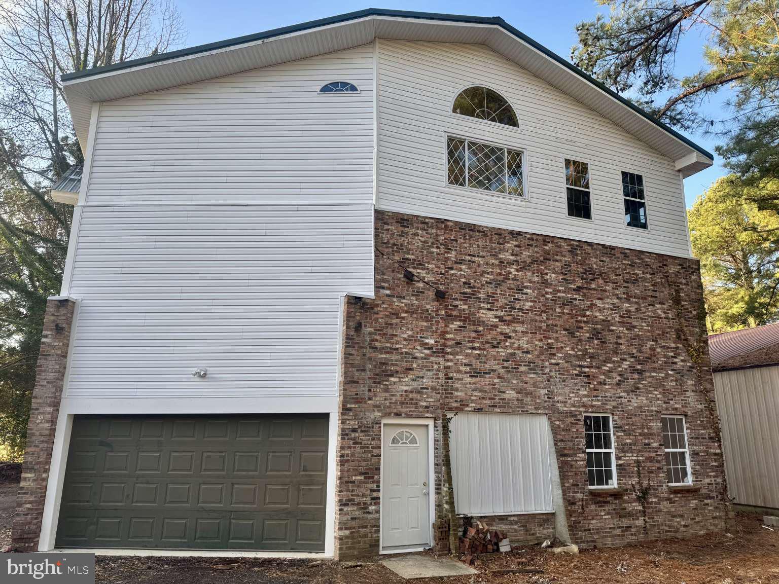 905 Crystal Rock Road Lusby, MD 20657 - Photo 15 of 22 a front view of a house with garage