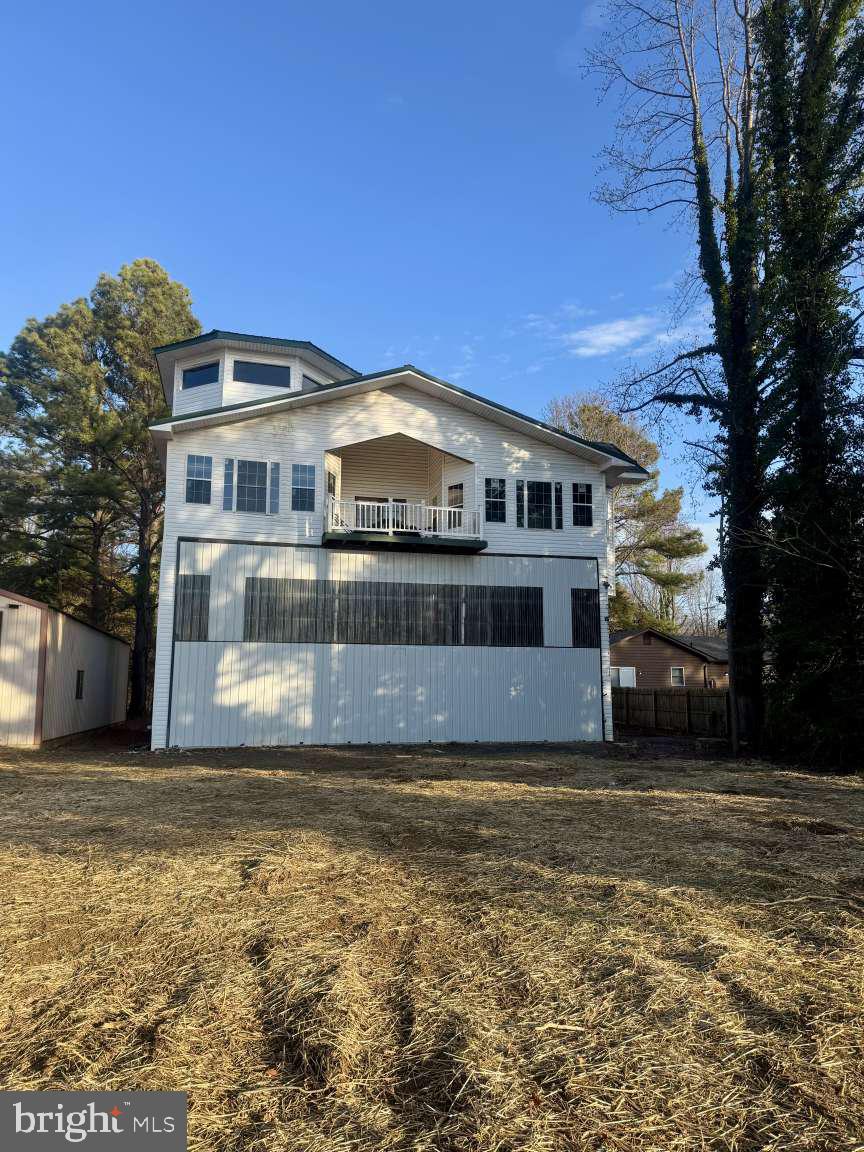 905 Crystal Rock Road Lusby, MD 20657 - Photo 20 of 22 a front view of a house with a garden
