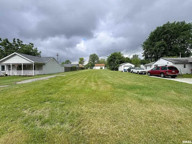 a view of a house with a yard and sitting area