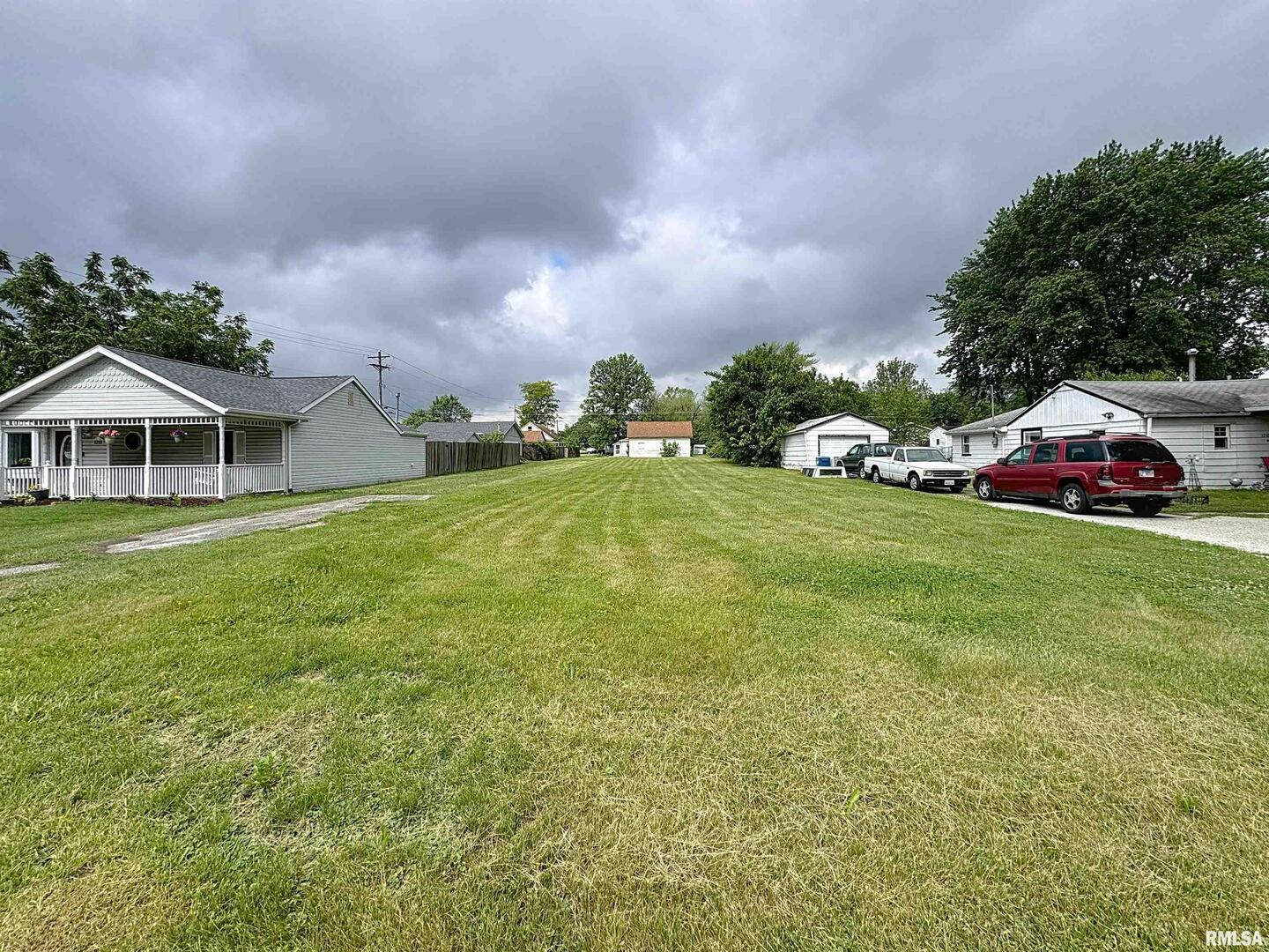 a view of a house with a yard and sitting area