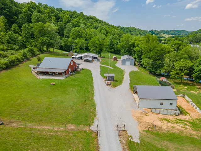an aerial view of a house with a garden and swimming pool