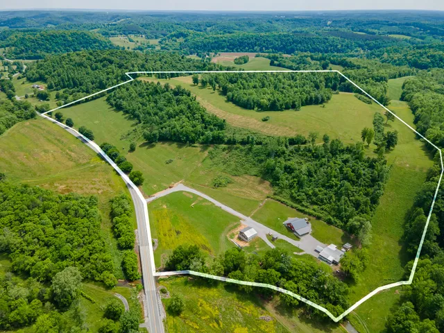 an aerial view of river residential houses with outdoor space and swimming pool