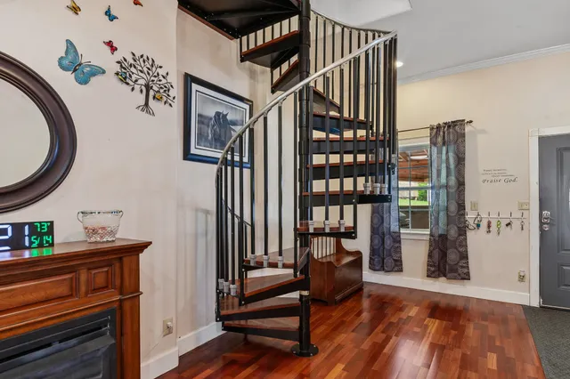 a view of a living room with furniture and wooden floor