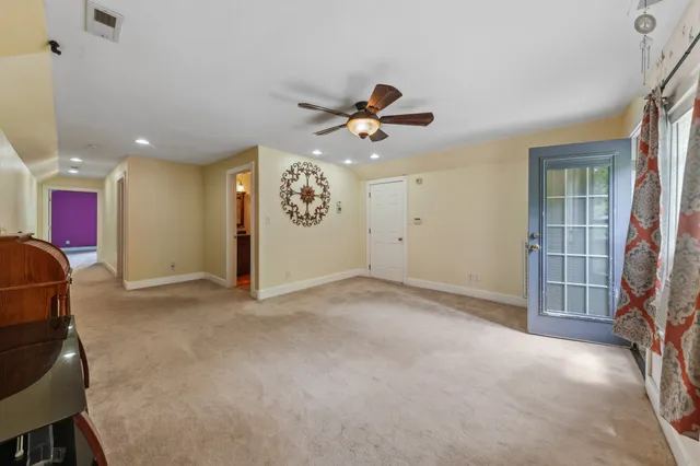 a bathroom with a granite countertop toilet a sink and a mirror