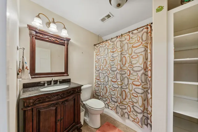 a spacious bedroom with a bed and a ceiling fan