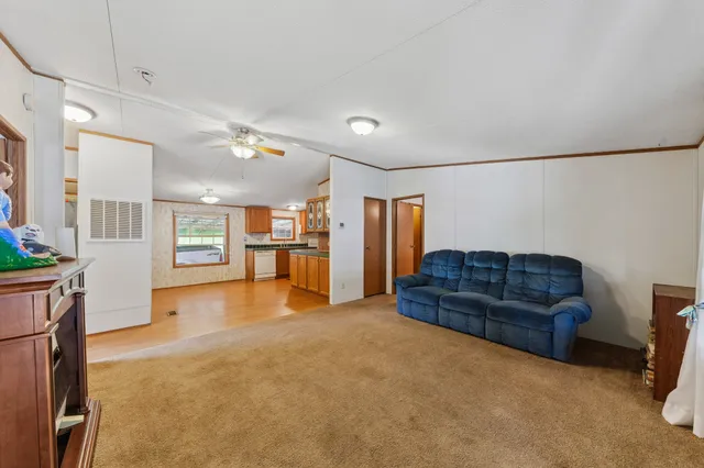 a living room with furniture and a kitchen
