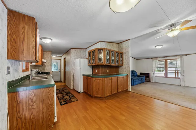 a room with a bed chandelier and a window