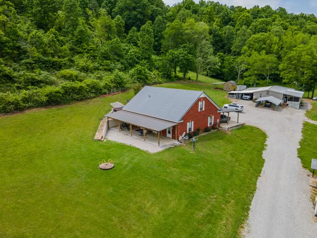 an aerial view of a house with swimming pool garden and patio