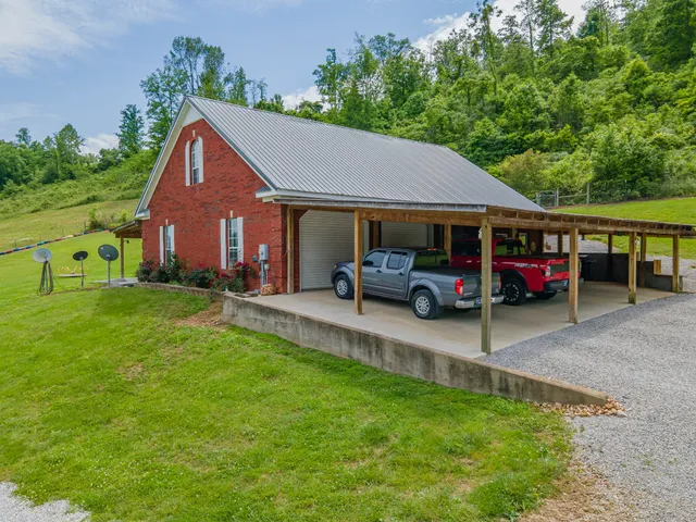 a view of a house with a small yard and sitting area