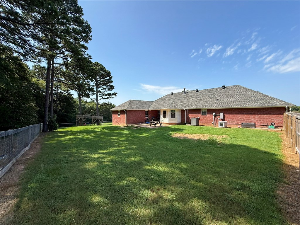 70 Walthall Road Russellville, AR 72802 - Photo 49 of 51 Spacious rear yard with a perimeter fence, mature trees, and a red brick exterior
