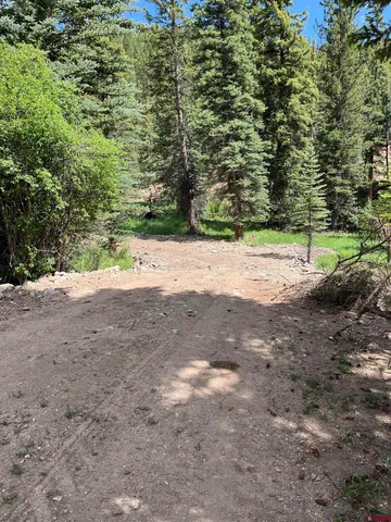 a view of a dirt road with a building