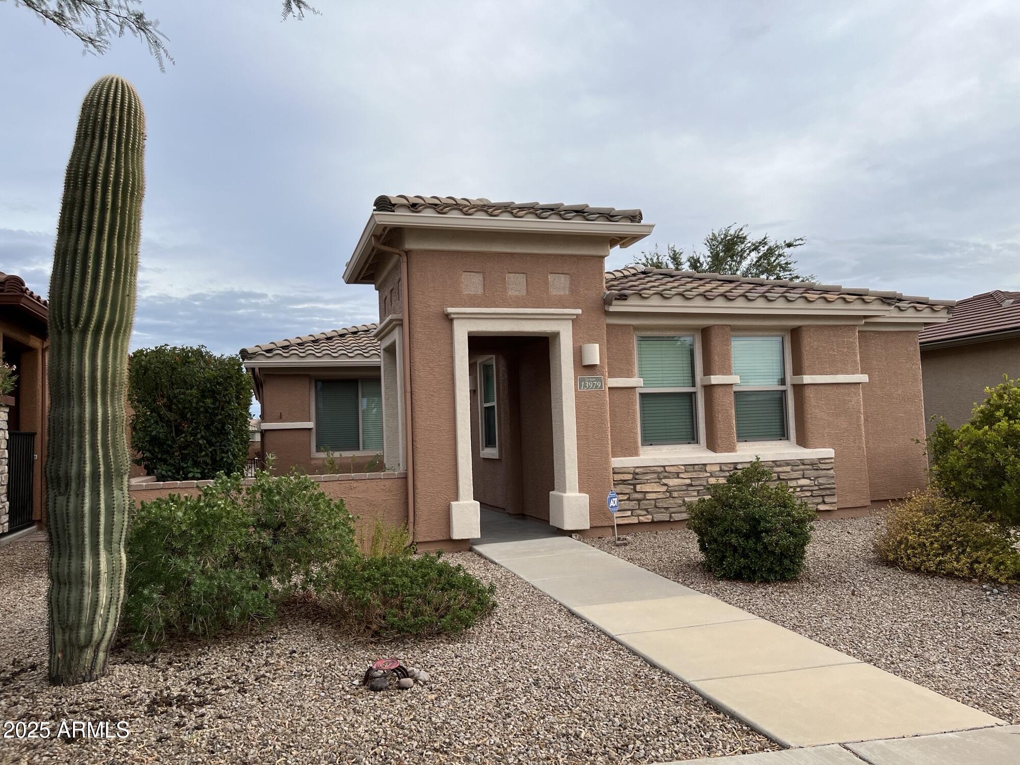a front view of a house with a garden