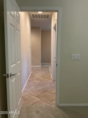 a view of a hallway with wooden shelves