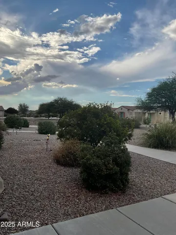 a view of a yard with wooden fence
